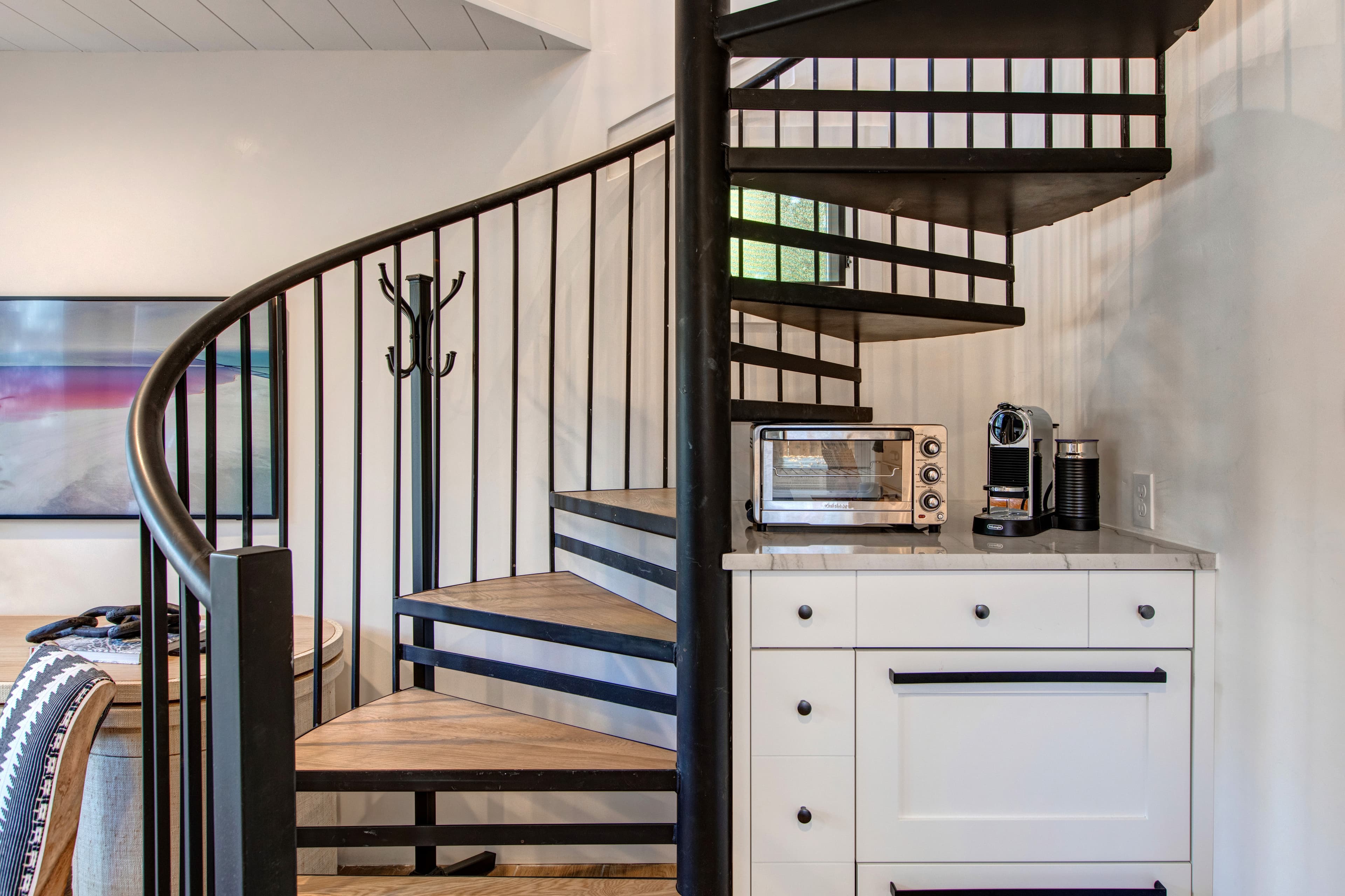 Detached guest suite accessed via the patio. Features a living area with a small kitchenette, TV, a desk and a queen sleeper sofa for additional guests.