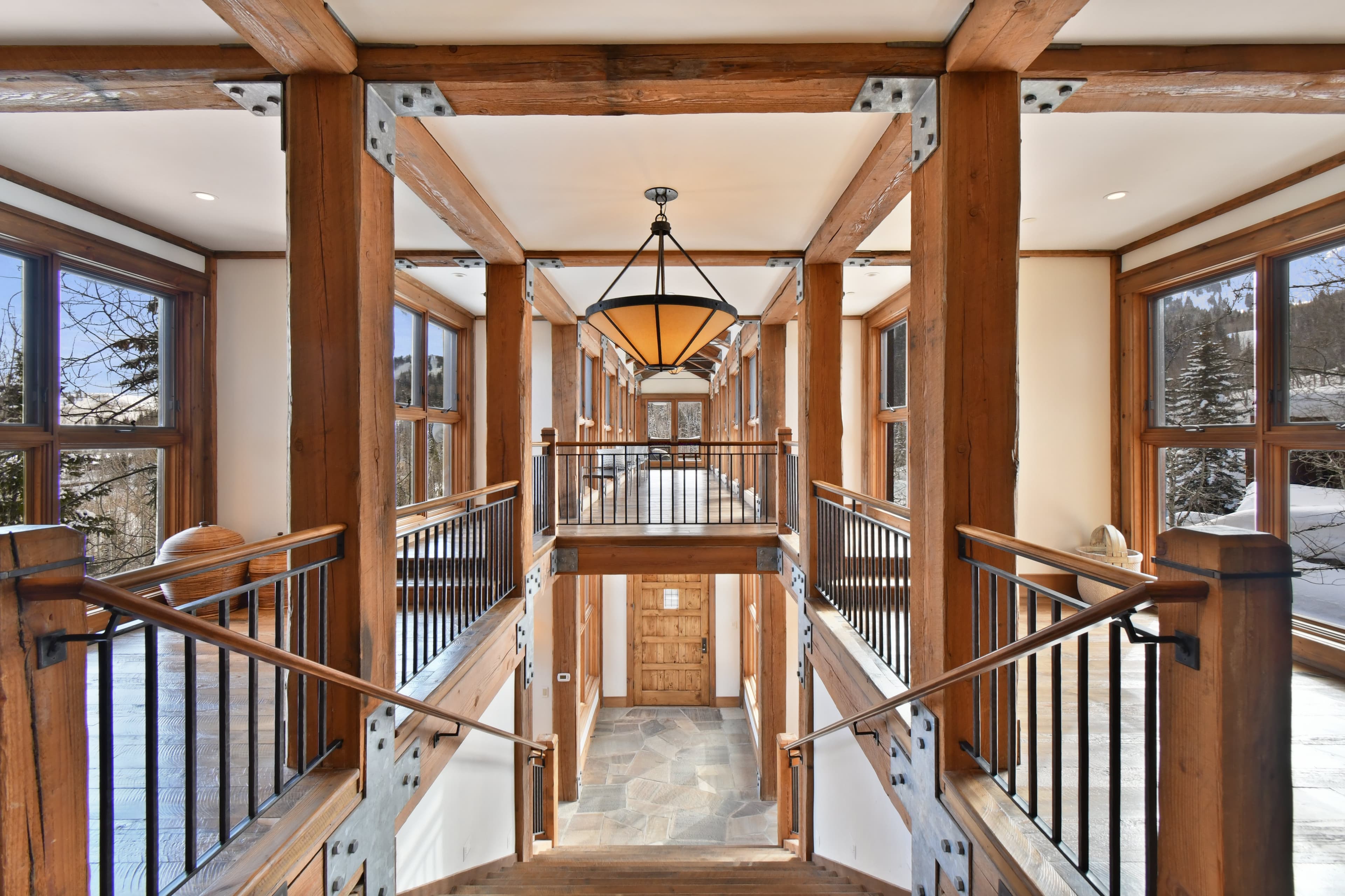 A look down the stairs leading to the entryway of the home, as taken from the upper floor.