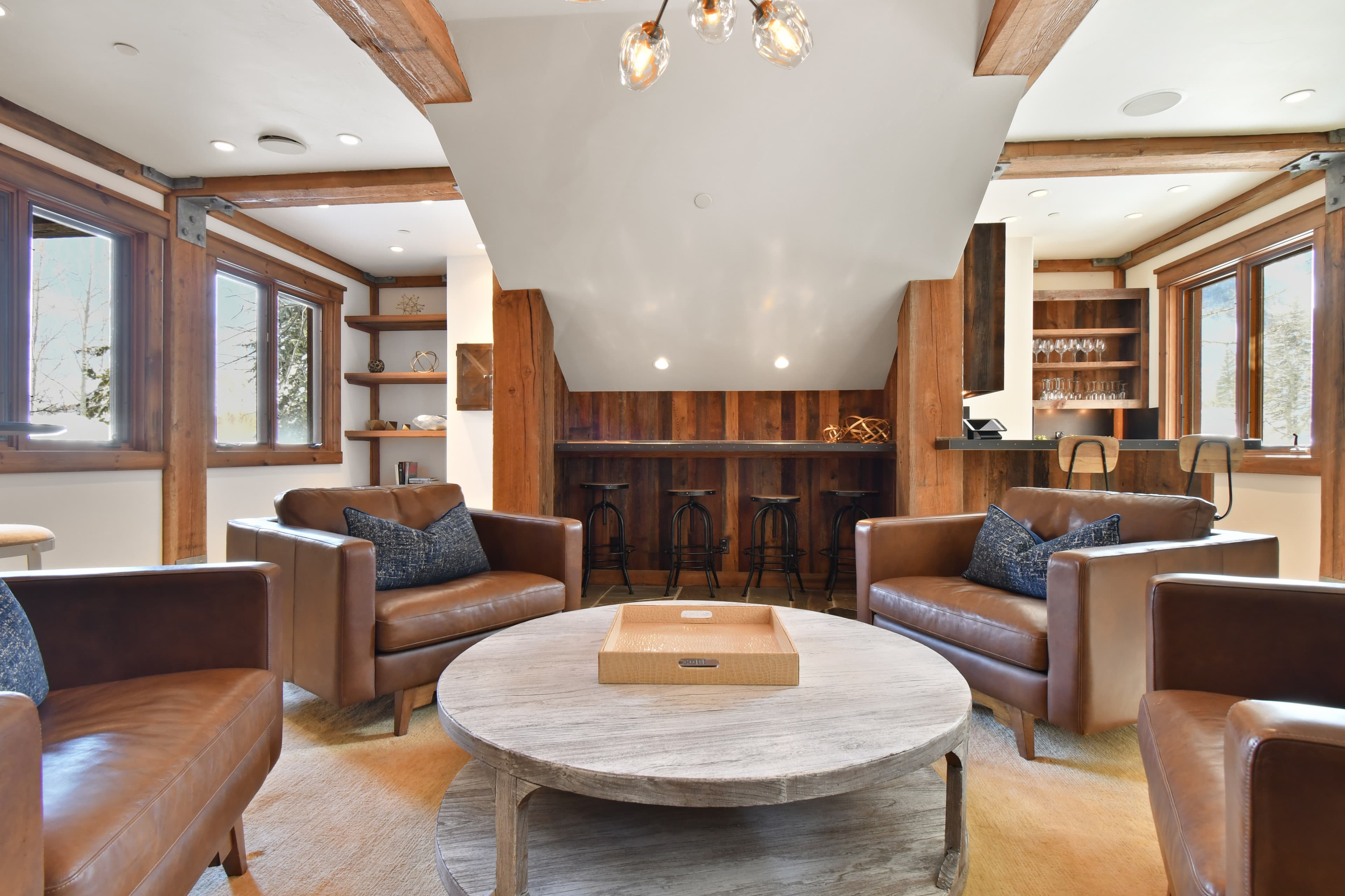 Four armchairs surround a circular granite table.