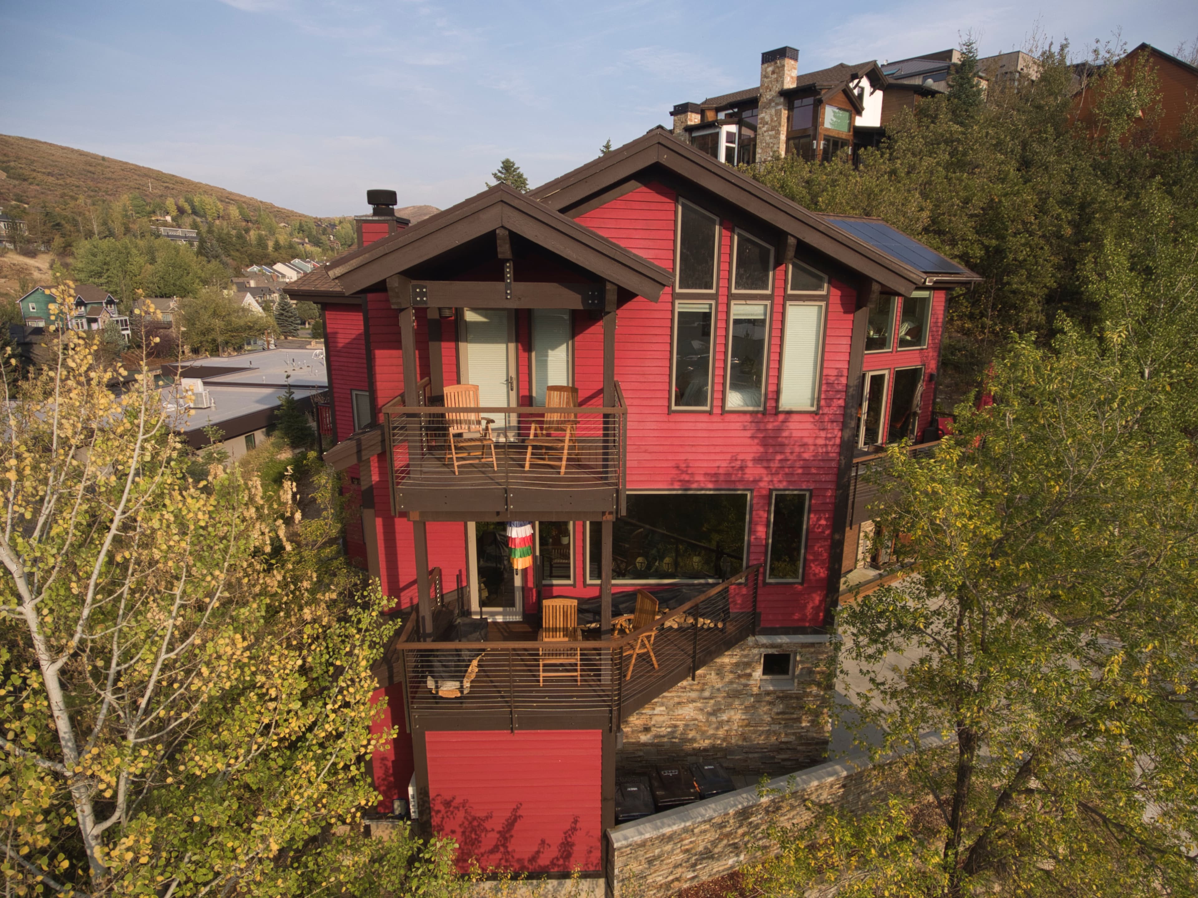 Balcony, Chairs, Large Windows,   Red Painted Two Story House