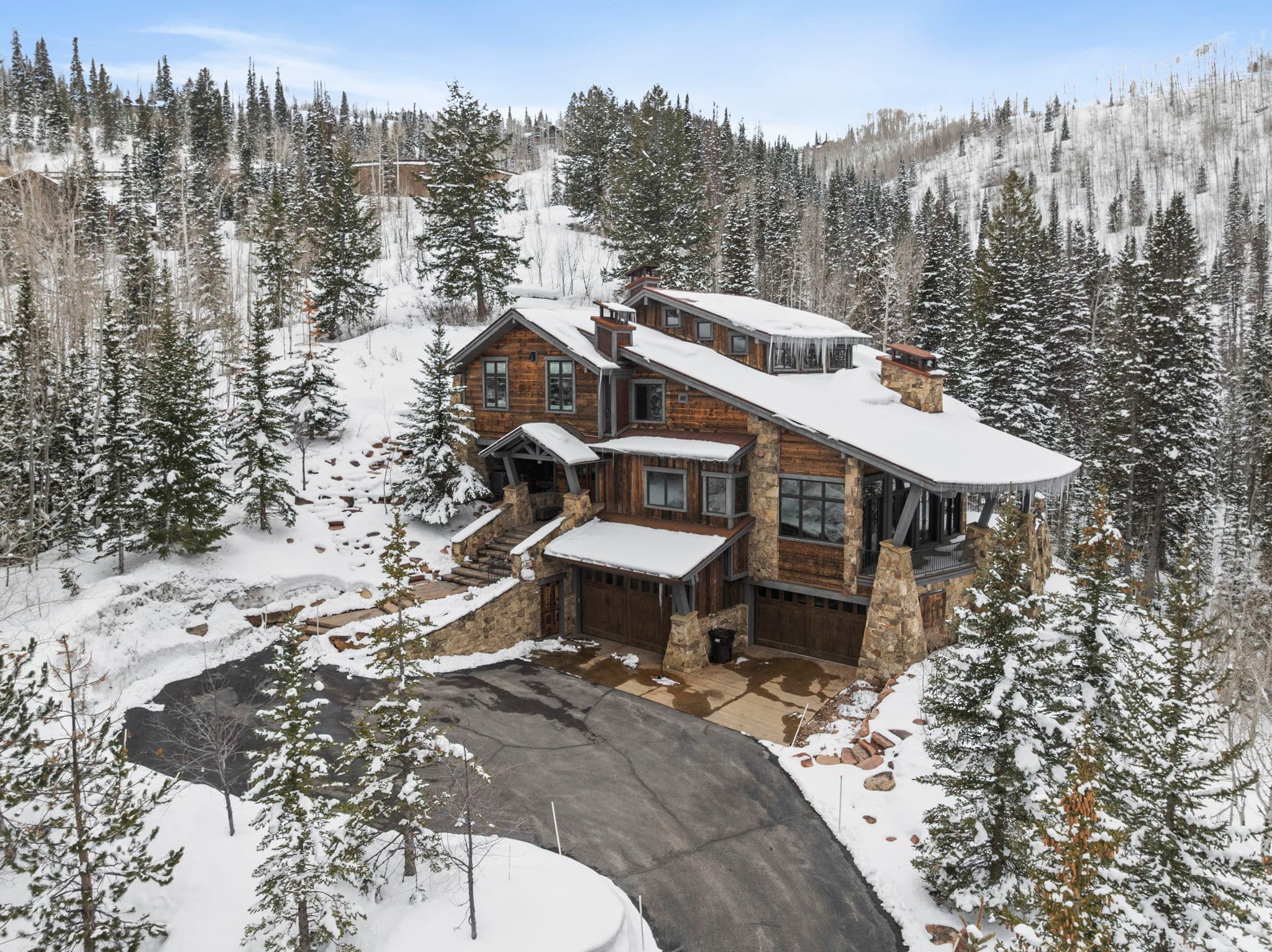 exterior view of the home with snow covered mountains in the background