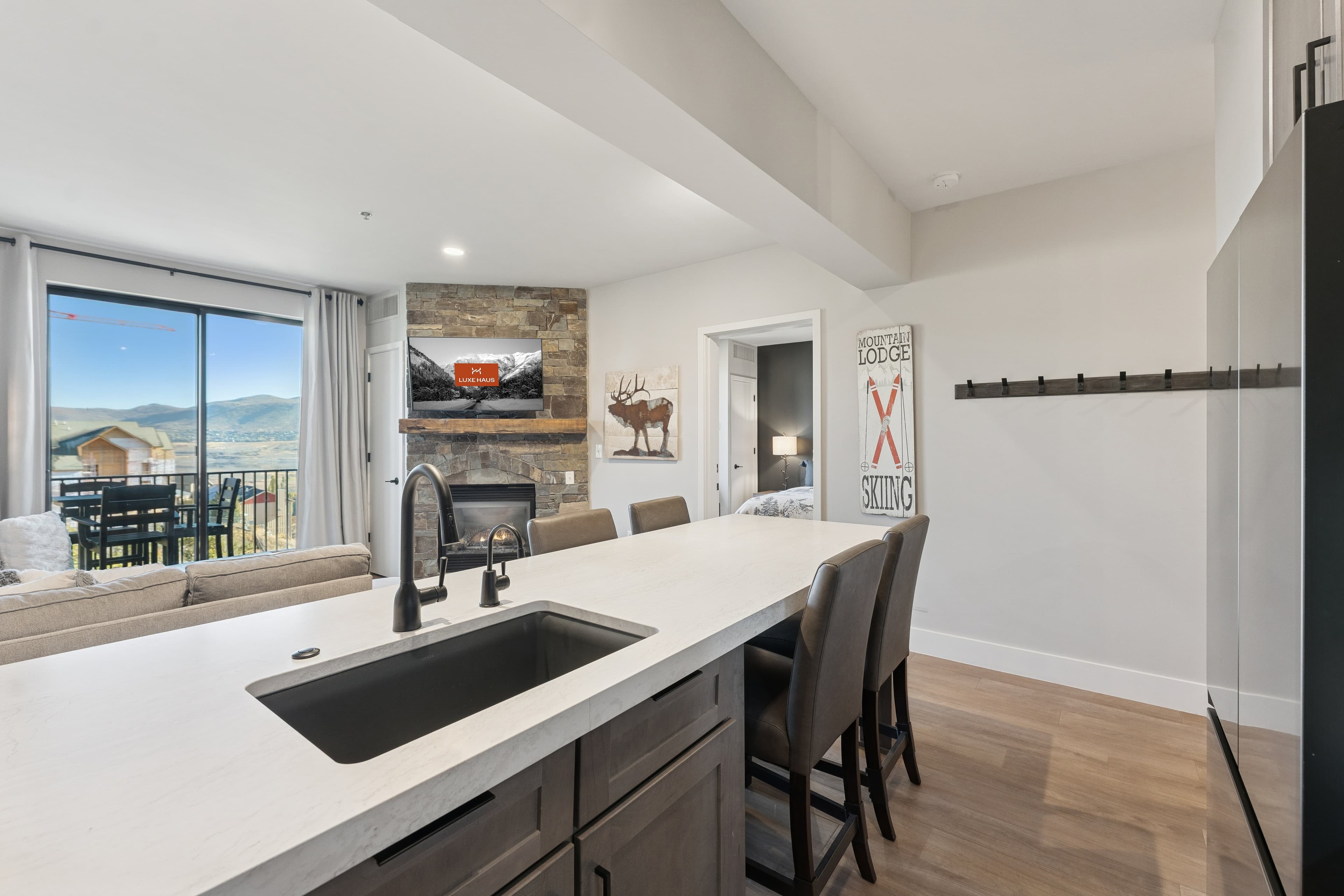 Elegant condo kitchen and dining area in Park City featuring upscale finishes, pendant lighting, and a warm alpine aesthetic.
